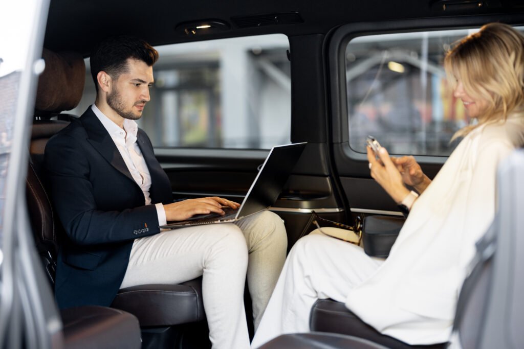 business people sitting in minivan taxi